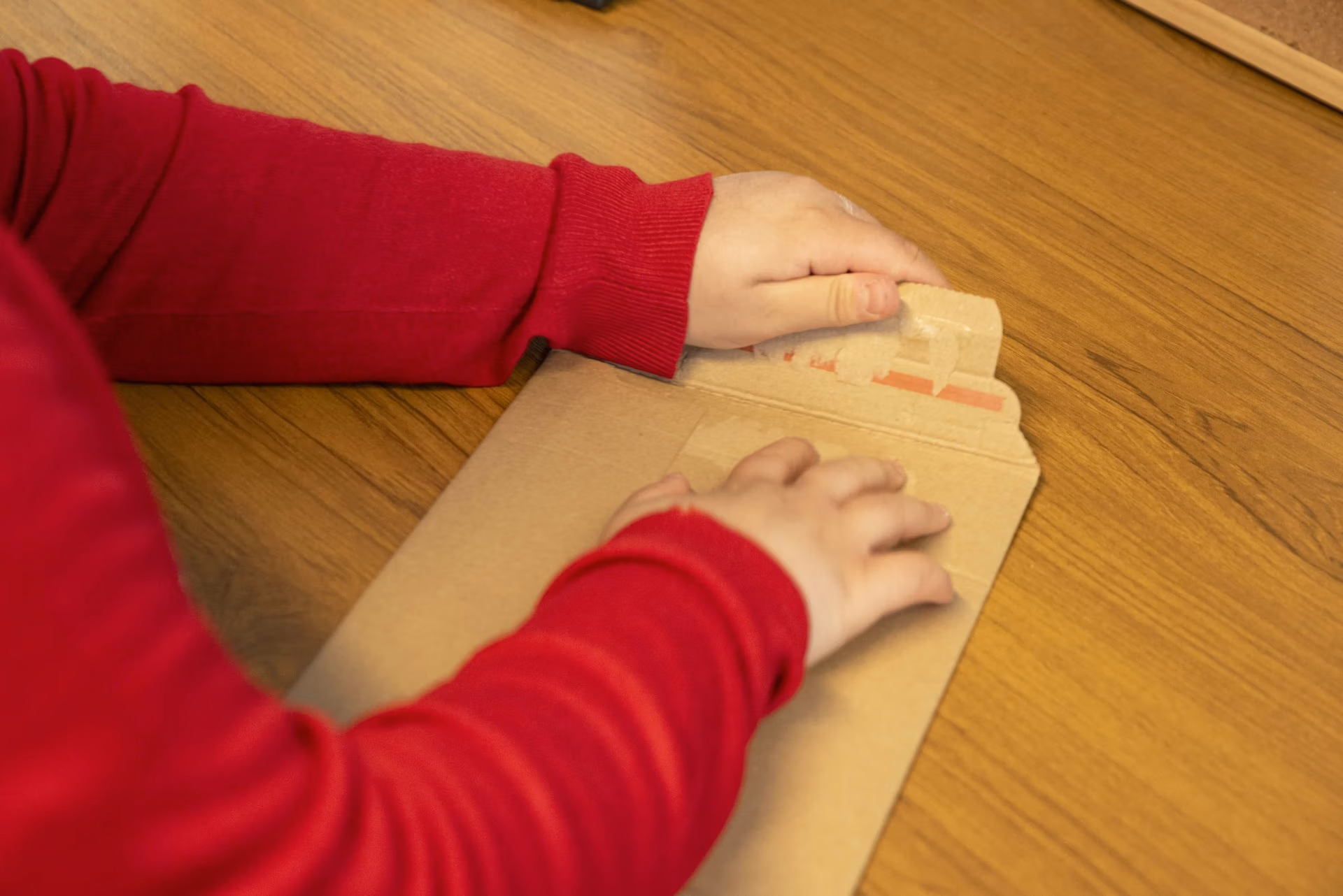 a cardboard mailer being opened
