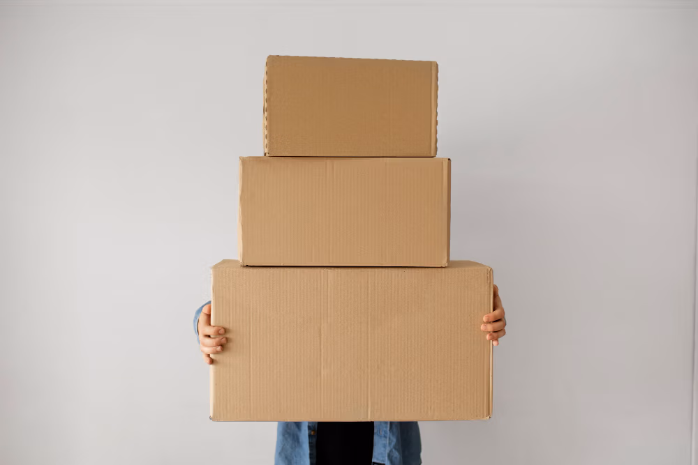 Person holding stack of boxes