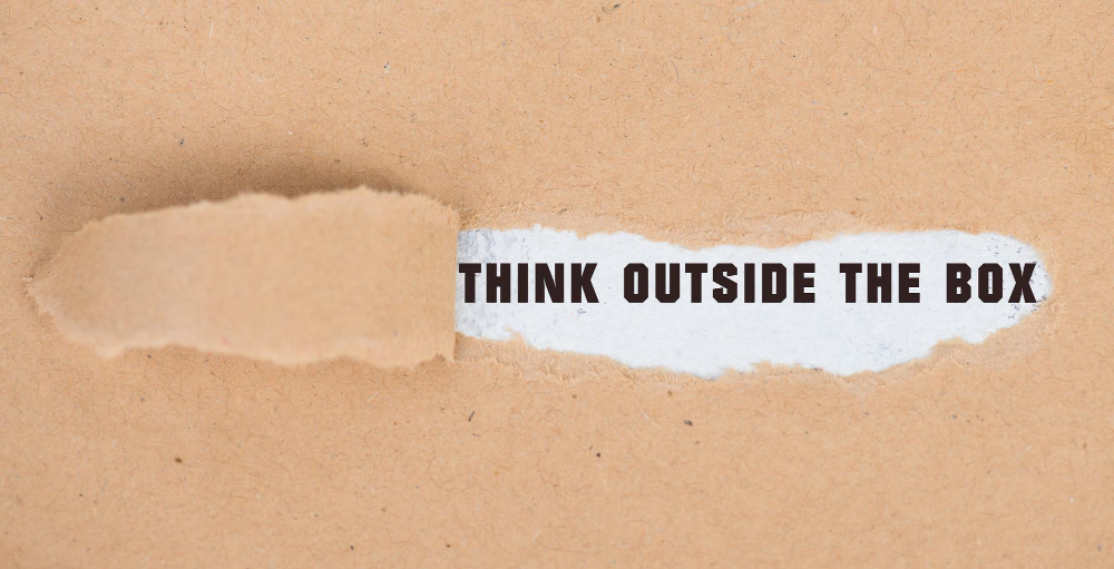 Think outside the box torn brown paper